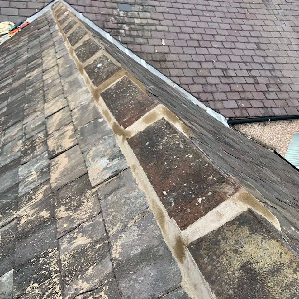 the top of a slate roof showing the ridge