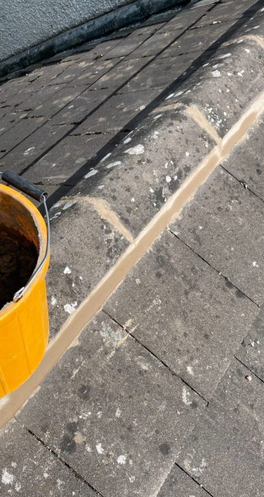 ridge repair work on a pitched tile roof