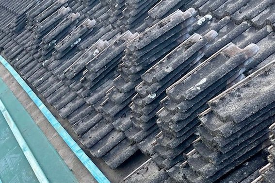 tiles stacked up on a pitched roof ready for laying