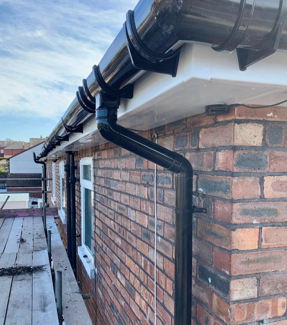 guttering and plastic facia board at the top of a house after repair work