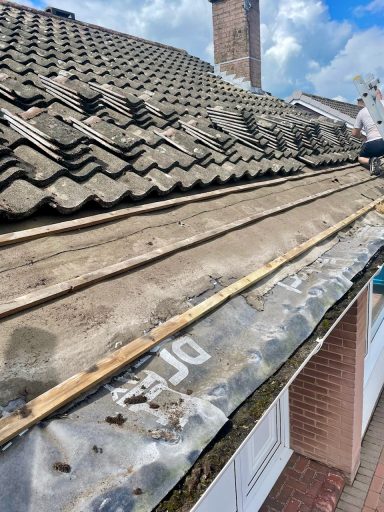 tiles being stripped on a roof prior to re fitting